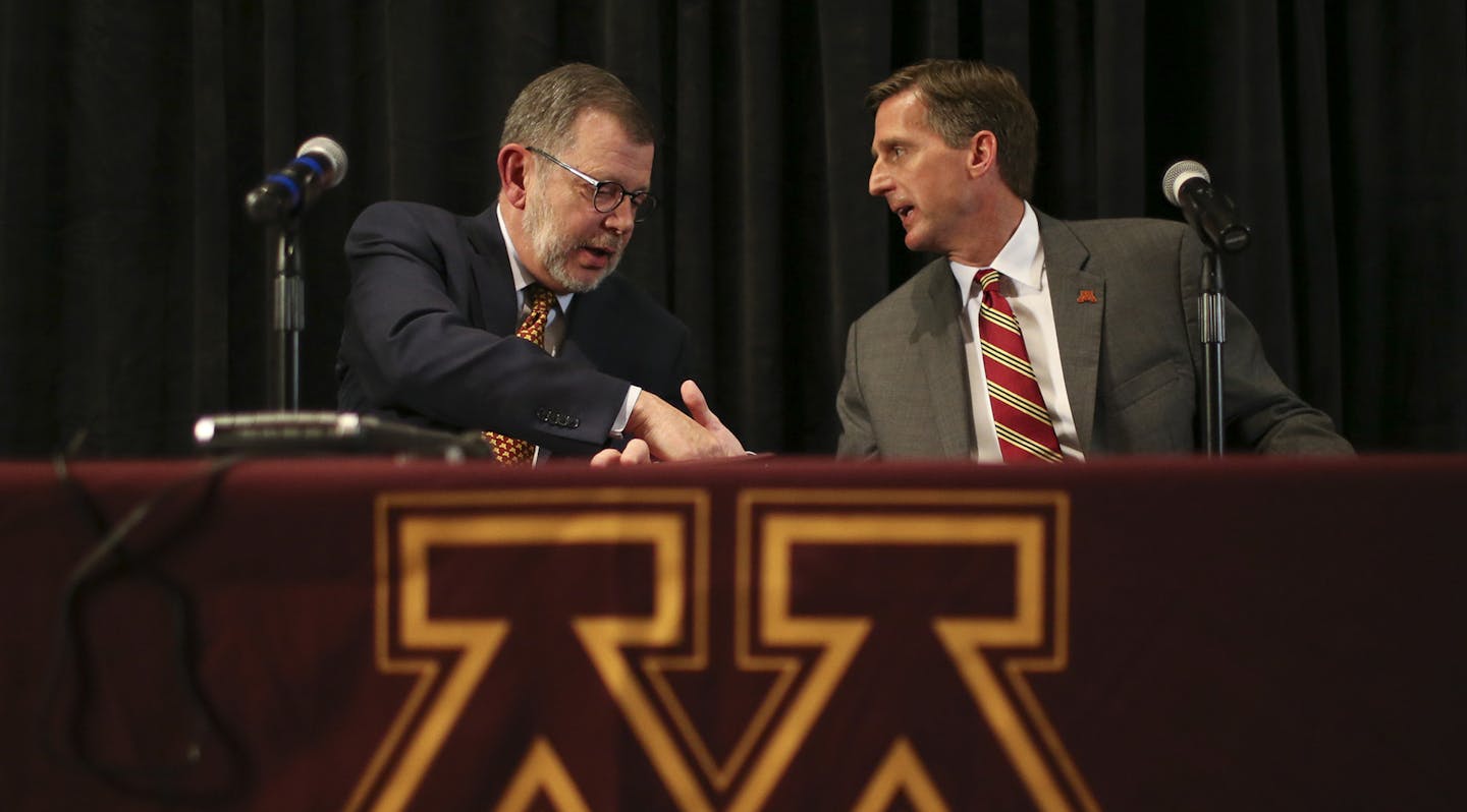 Mark Coyle, right, shakes hands with Minnesota President Eric Kaler after a news conference at which Coyle was introduced as the university's new athletic director, Wednesday, May 11, 2016, in Minneapolis. (Jeff Wheeler/Star Tribune via AP) ORG XMIT: MIN2016051213503151