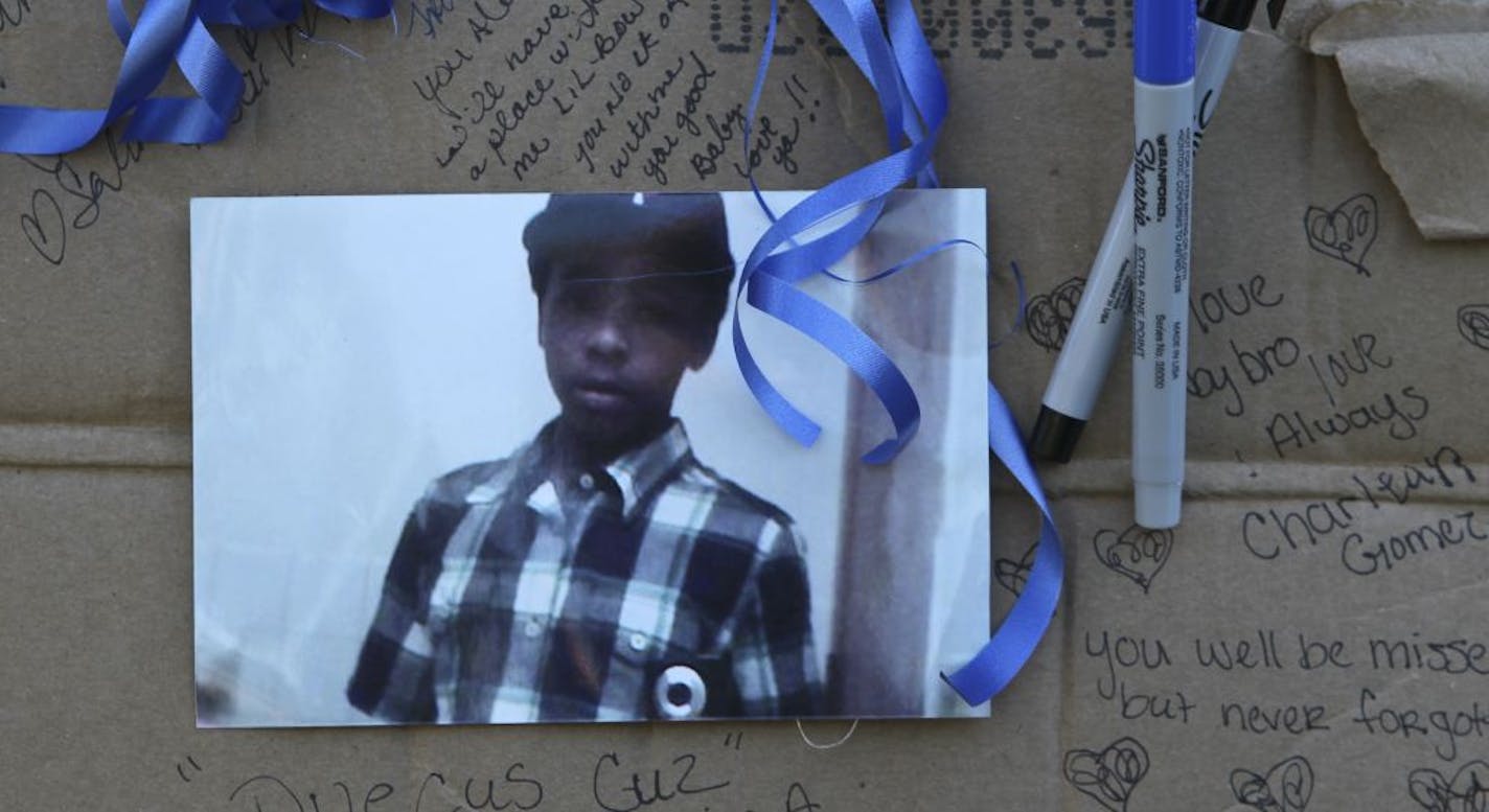 A photo of 13-year-old shooting victim Ray'Jon Gomez at a makeshift memorial where the shooting victim was found in Minneapolis, MN.