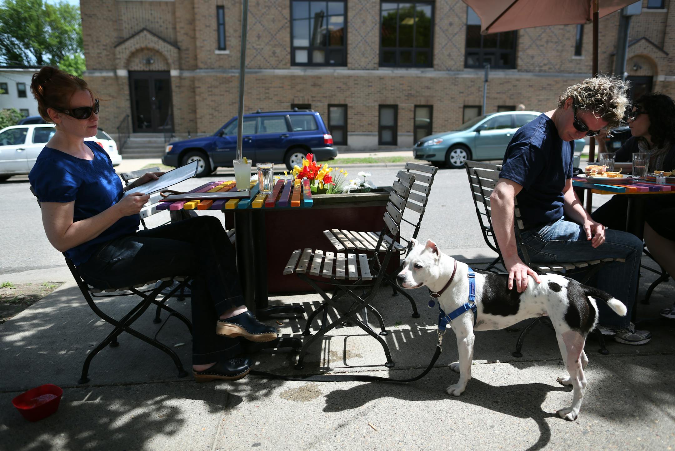 Anna Lundberg's dog Dottie was happy to get a patdown from Bob Kelly at the neighboring table at Cafe Barbette's dog-friendly outdoor seating on Friday, May 4, 2012 in Minneapolis, Minn. ] (RENEE JONES SCHNEIDER/ reneejones@startribune.com) Anna Lundberg, Bob kelly