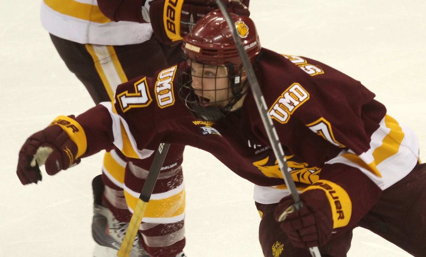 NCAA Frozen Four Finals, Minnesota Duluth vs Michigan. (left to right) Minnesota Duluth's Kyle Schmidt celebrated his overtime goal and the Bulldogs national championship win over Michigan.