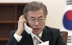 South Korean President Moon Jae-in talks on the phone with Chinese President Xi Jinping at the presidential Blue House in Seoul, South Korea, Thursday