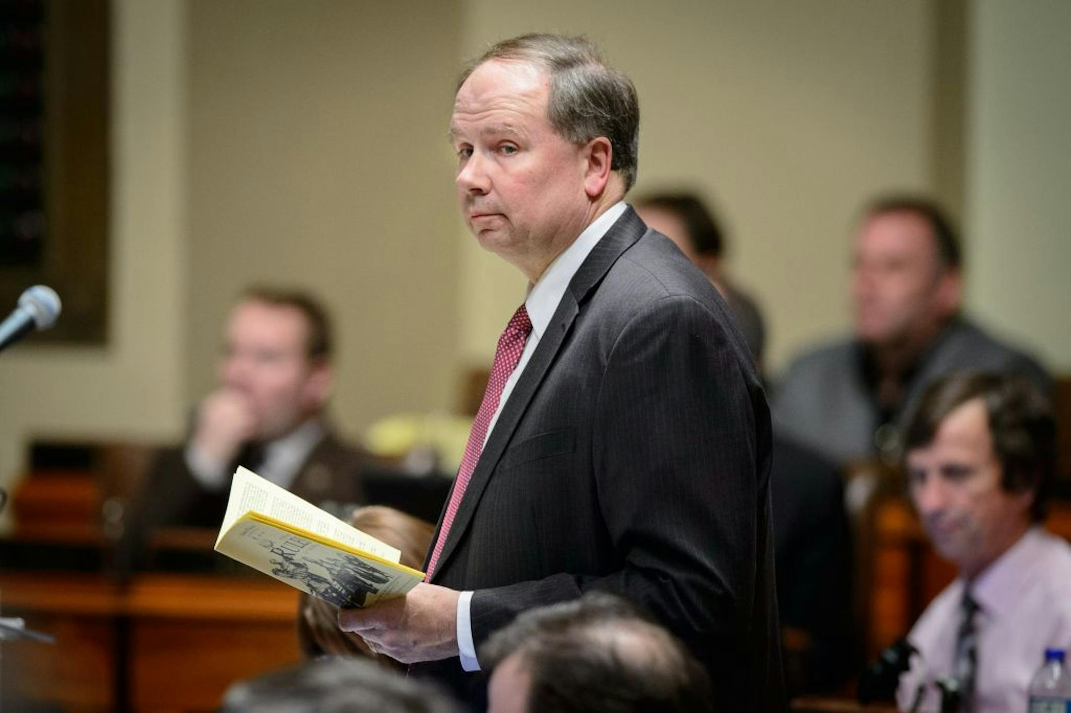 Rep Jim Knoblach, R- St. Cloud, held a copy of the House rules book as he fought off amendments to the teacher seniority bill because they would cost money and would be in violation of House Rules.