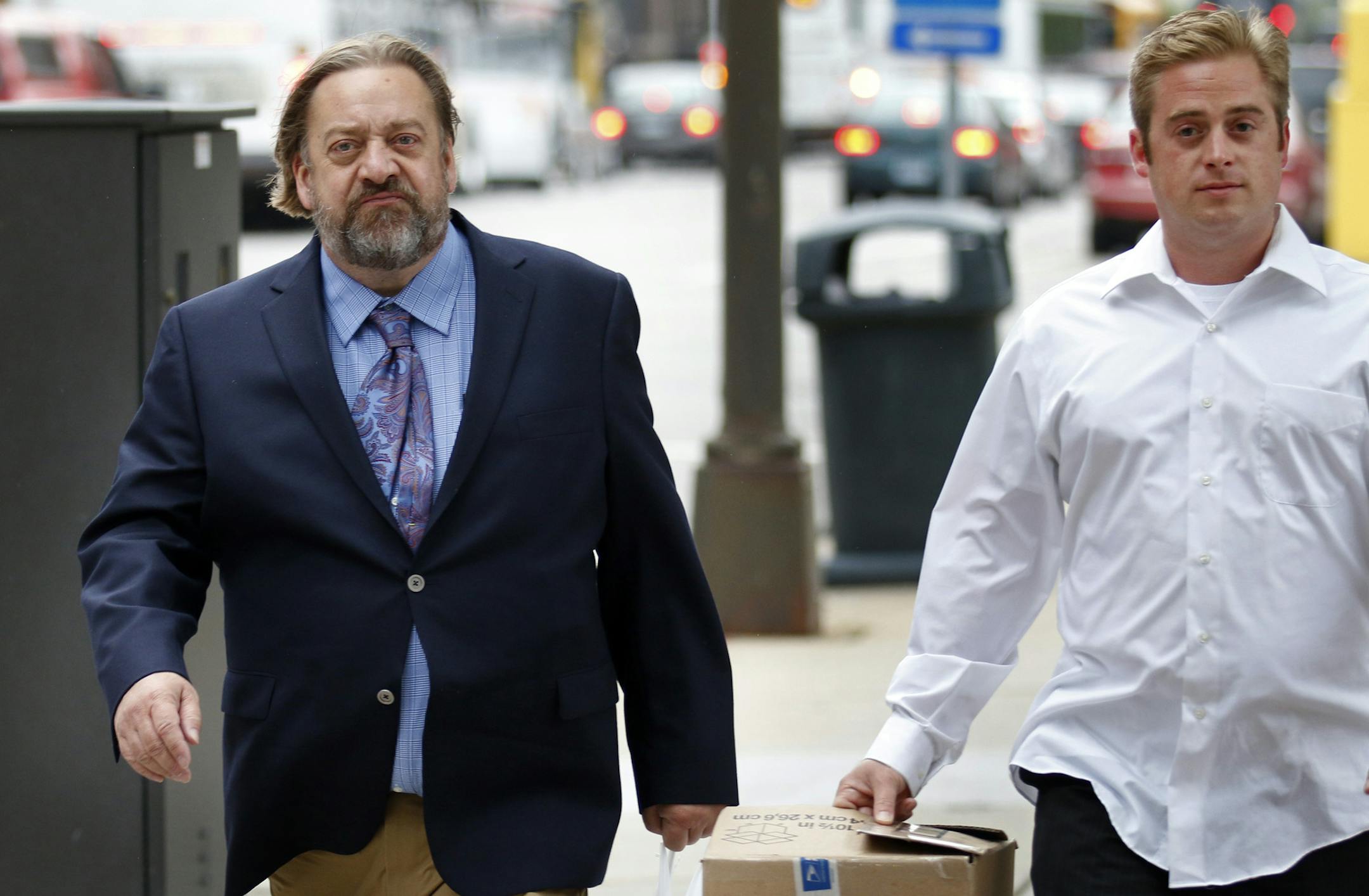 Jim Carlson (left), owner of Last Place on Earth, faces 54 counts of violating federal drug and regulatory laws. Opening arguments Tuesday afternoon in the federal trial the Duluth head shop owner and two workers including Carlson's son Joseph Gellerman (right). Here, Carlson and Gellerman walk downtown Minneapolis after court Wednesday afternoon.] BRIAN PETERSON ‚Ä¢ brianp@startribune.com Minneapolis, MN - 09/17//2013