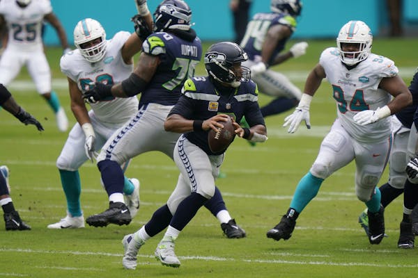 Seattle Seahawks quarterback Russell Wilson (3) runs with the ball during the first half of an NFL football game against the Miami Dolphins, Sunday, O