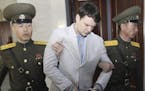American student Otto Warmbier, center, was escorted at the Supreme Court in Pyongyang, North Korea, Wednesday, March 16, 2016.