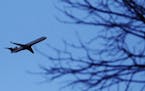 A plane that took off from MSP cruises over a Southwest Minneapolis neighborhood near the Crosstown and Oliver Ave. S Wednesday, Oct. 31, 2012, in Min