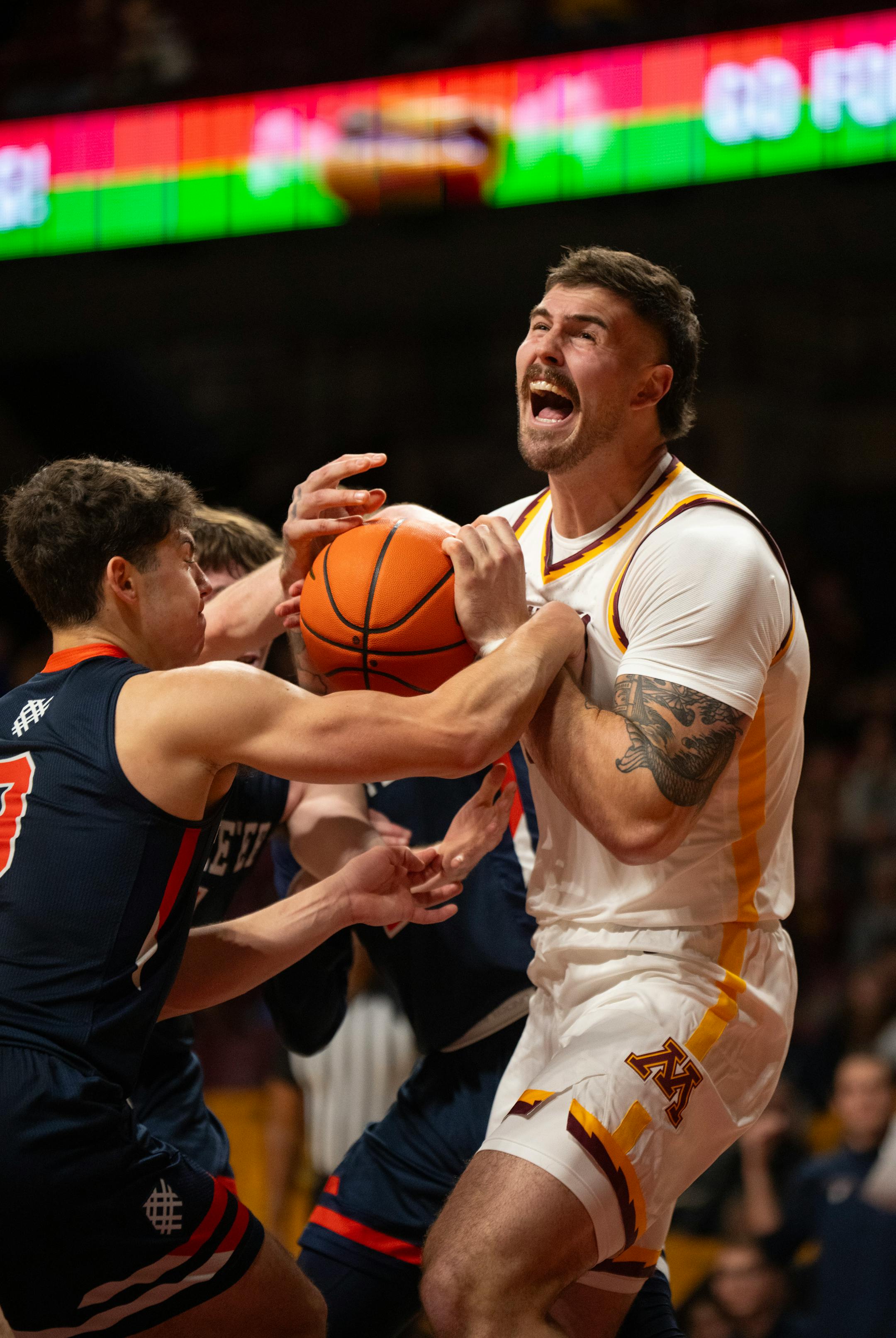Minnesota Gophers center Jack Wilson (33) was fouled as he struggled with a trio of Macalester players for the ball.
