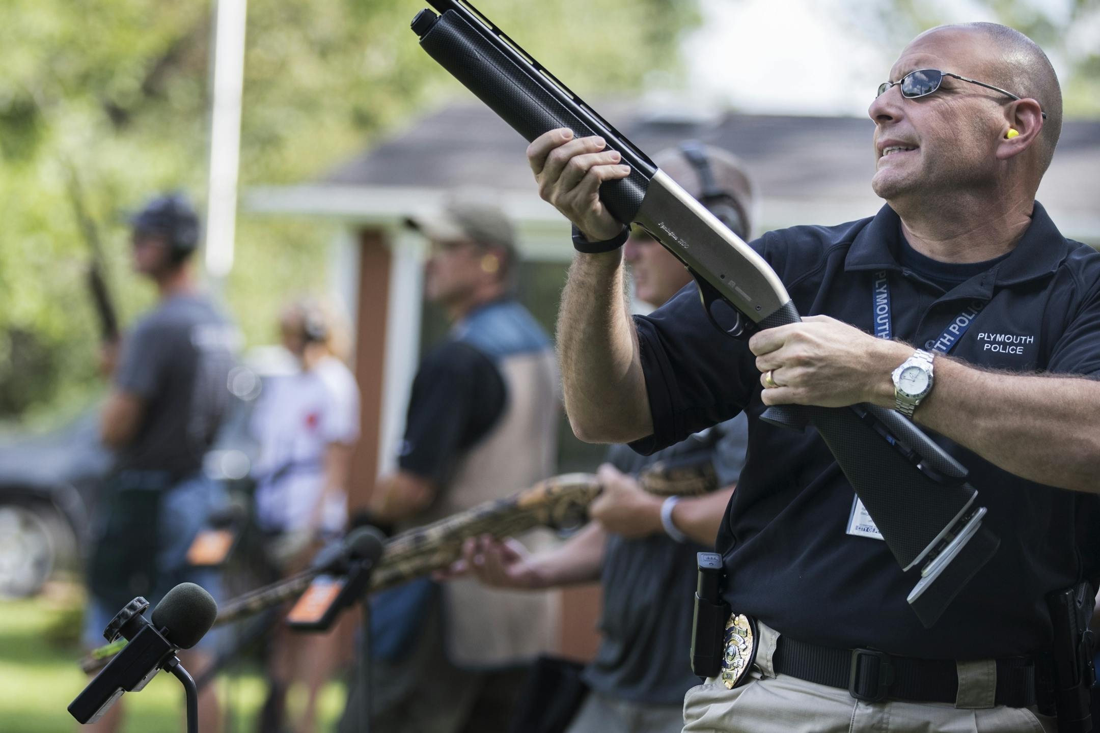 Plymouth Police chief Mike Goldstein grimaces after missing a shot during a friendly trap shooting competition with the Wayzata High School Trap Team.