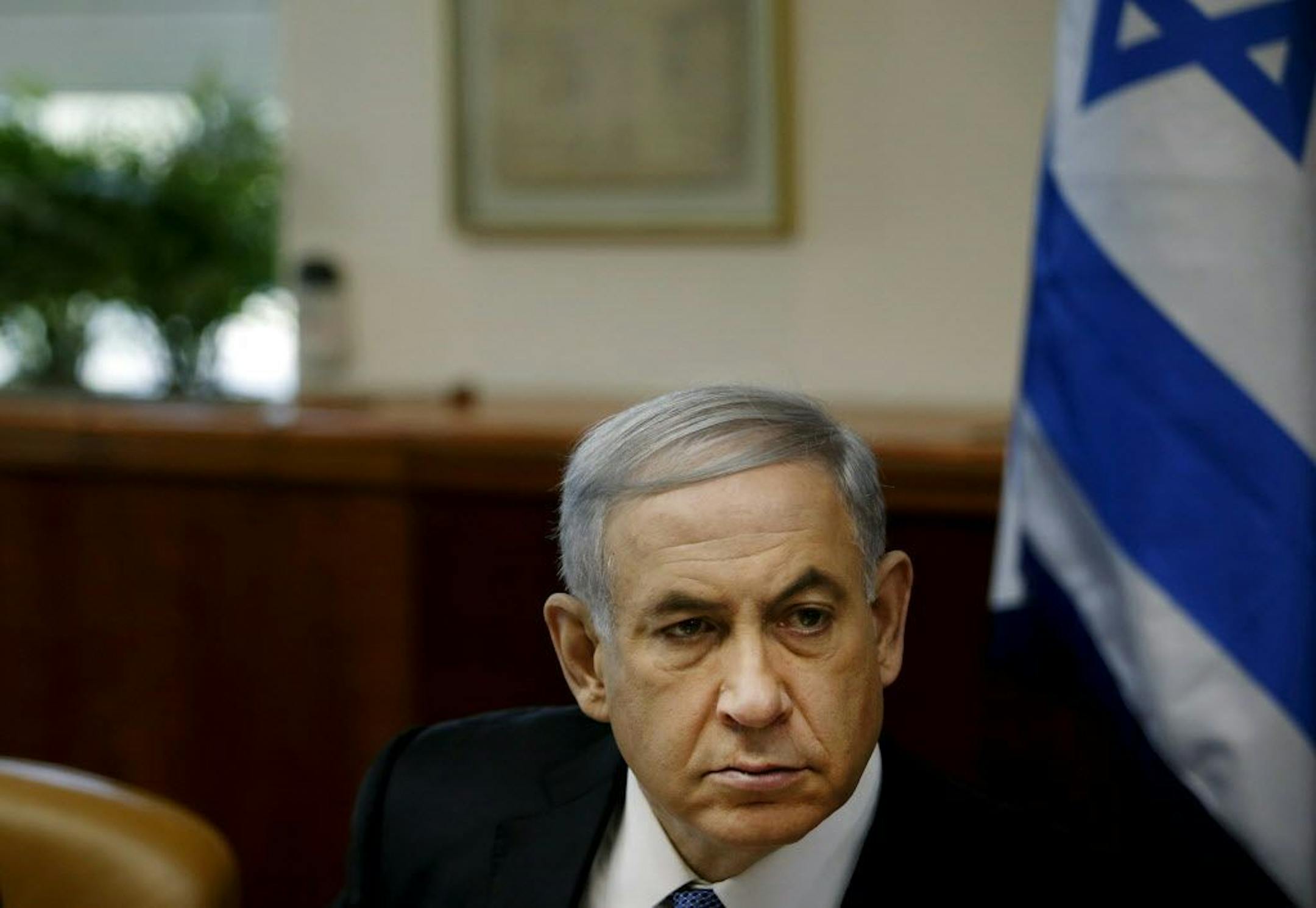 Israel's Prime Minister Benjamin Netanyahu chairs the weekly cabinet meeting in Jerusalem, Sunday, Nov. 30, 2014. Israel's prime minister said Sunday that the public expects the government to "return to normal conduct" and hinted at the possibility of early elections if his coalition does not overcome a crisis linked to a contentious nationality bill that would enshrine Israel's status as a Jewish state. The proposal would also make Jewish law a source of legislative inspiration and delist Arabi