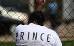 A woman wept as she grabbed a fence outside Paisley Park.