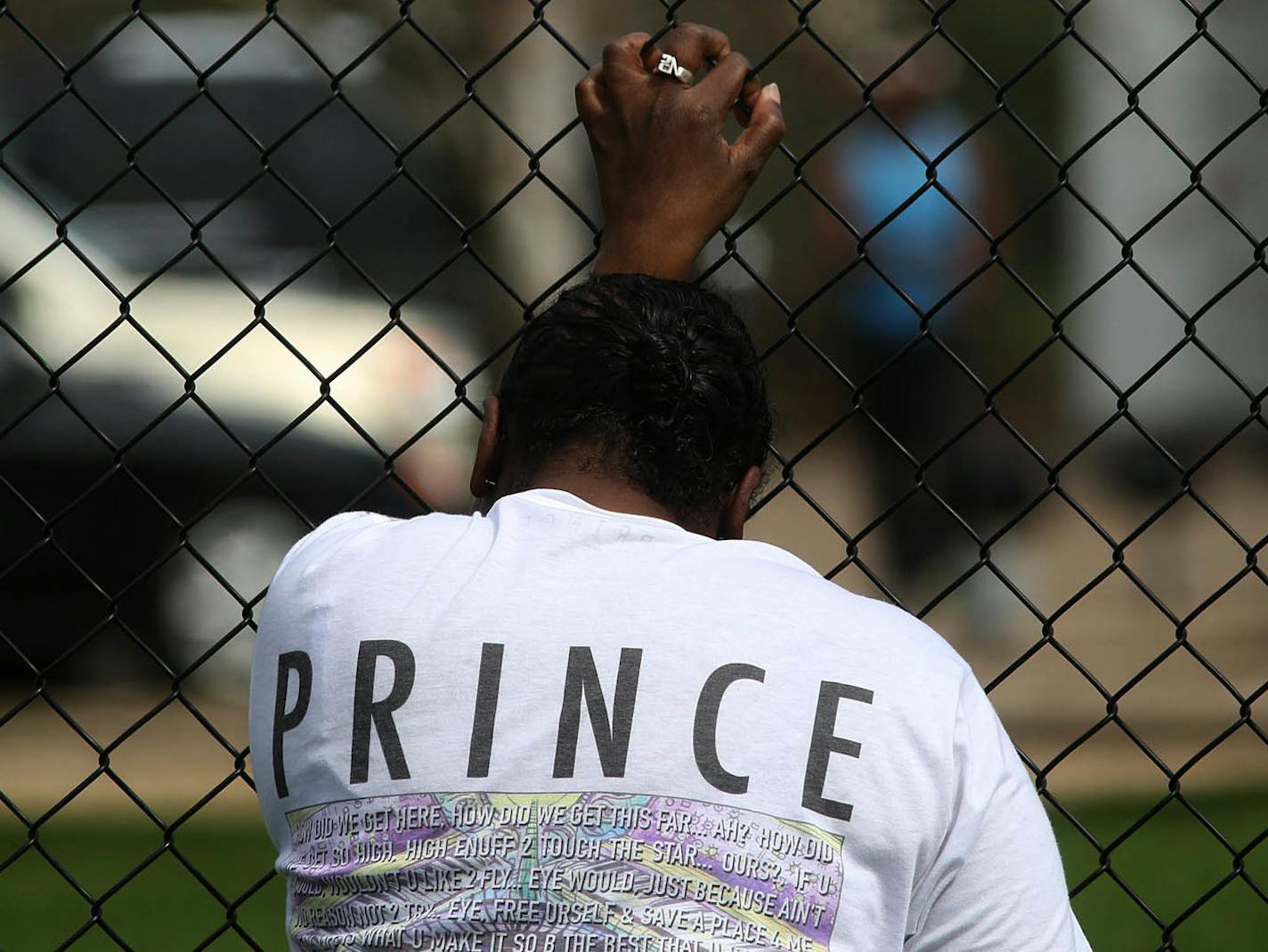 A woman wept as she grabbed a fence outside Paisley Park.