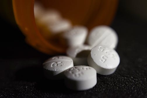 This Tuesday, Aug. 15, 2017 photo shows an arrangement of pills of the opioid oxycodone-acetaminophen in New York. Abuse of painkillers, heroin, fentanyl and other opioids across the country has resulted in tens of thousands of children being taken from their homes and placed in the foster care system. (AP Photo/Patrick Sison)