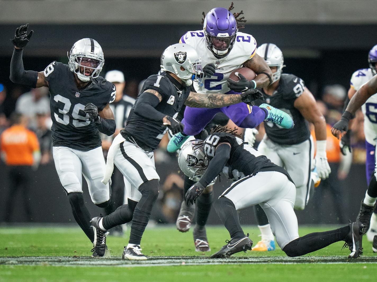 Minnesota Vikings running back Alexander Mattison (2) jumped over Las Vegas Raiders safety Tre'von Moehrig (25) picking up a first down in the second quarter Sunday December ,10 ,2023 in,Las Vegas, Nev. ] JERRY HOLT • jerry.holt@startribune.com