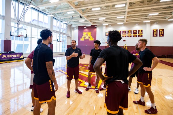 Gophers coach Ben Johnson worked with his players during a summer practice.