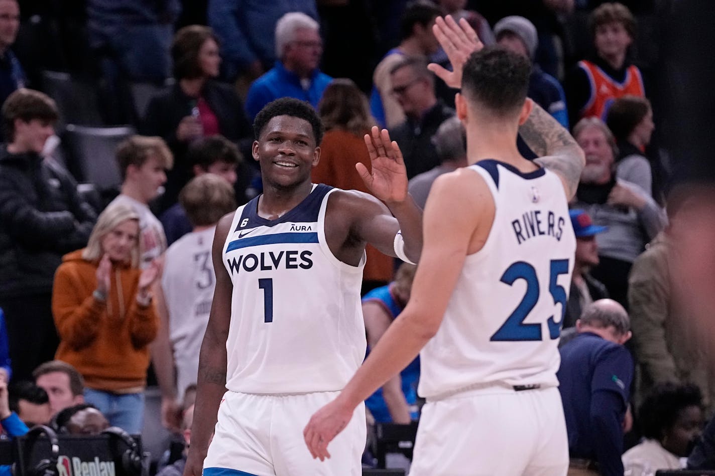 Minnesota Timberwolves guard Anthony Edwards (1) and guard Austin Rivers (25) celebrate after the Timberwolves defeated the Oklahoma City Thunder in an NBA basketball game Friday, Dec. 16, 2022, in Oklahoma City. (AP Photo/Sue Ogrocki)