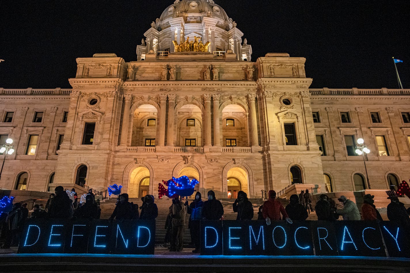 Supporters of The Spotlight on Democracy rally on the steps of the State Capitol in St. Paul, Minn., on Thursday, Jan. 6, 2022. Minnesotans will rally on the steps of their state capitol that evening to say that, in America, voters decide the outcome of elections. In 2021 more than 360 voter-suppression bills were introduced in 47 states, including Minnesota. RICHARD TSONG-TAATARII • richard.tsong-taatarii@startribune.com