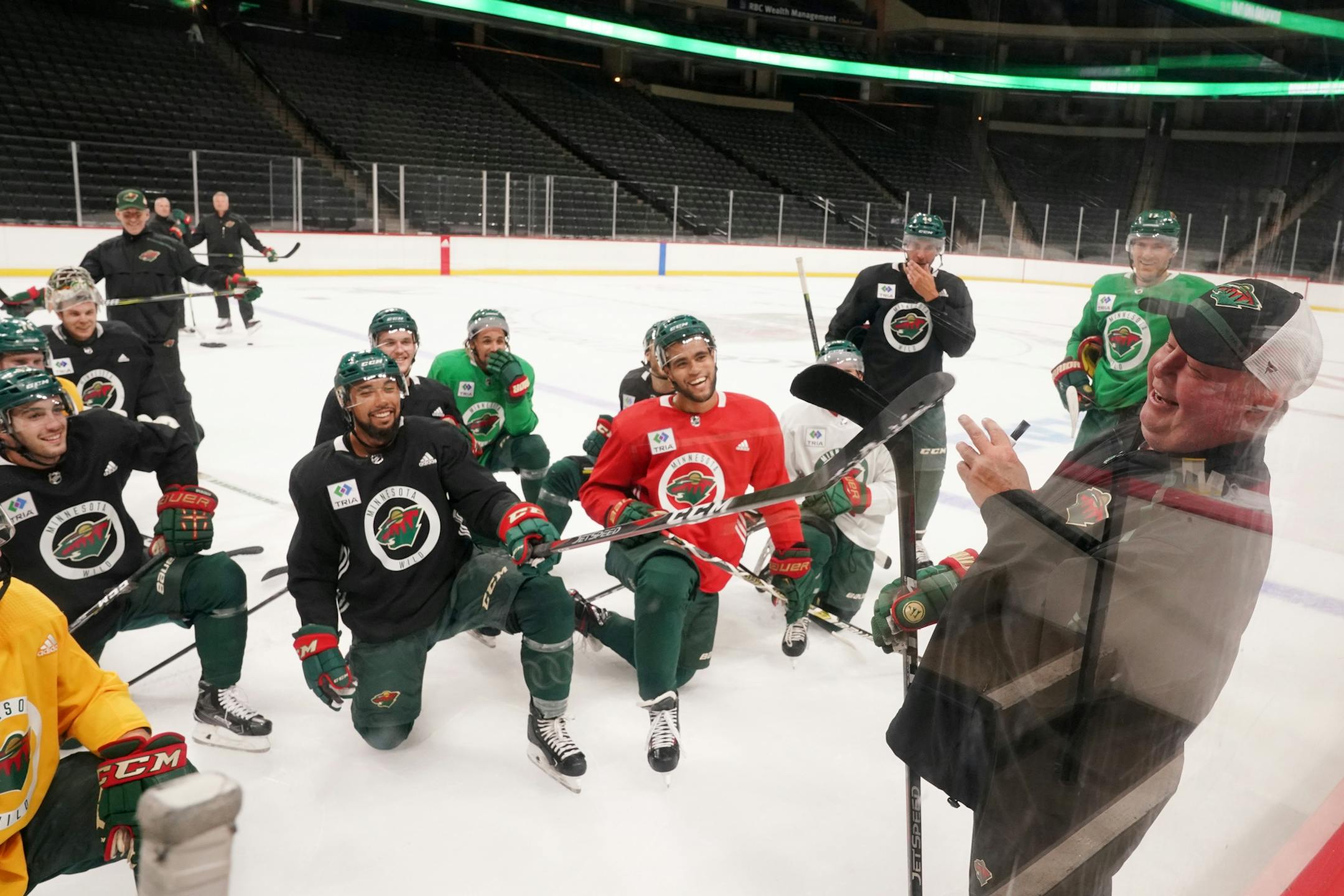 Minnesota Wild defenseman Matt Dumba (24) waved his stick at Minnesota Wild head coach Bruce Boudreau as he talked with players between drills.