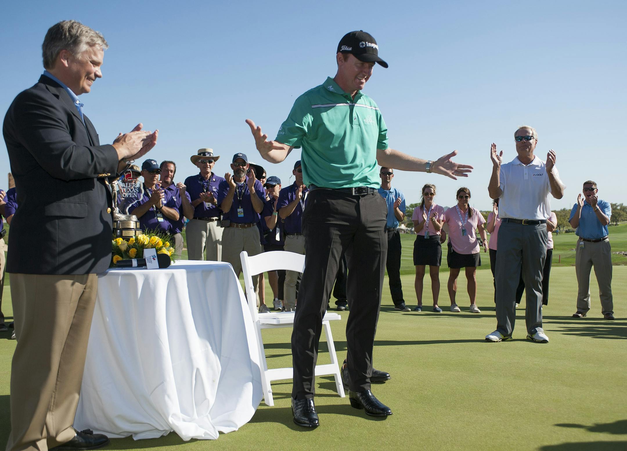 Jimmy Walker wears the tournament-trophy boots after winning the Texas Open golf tournament, Sunday, March 29, 2015, in San Antonio. Walker finished at 11 under par, with a four-stroke margin over Jordan Spieth. (AP Photo/Darren Abate)