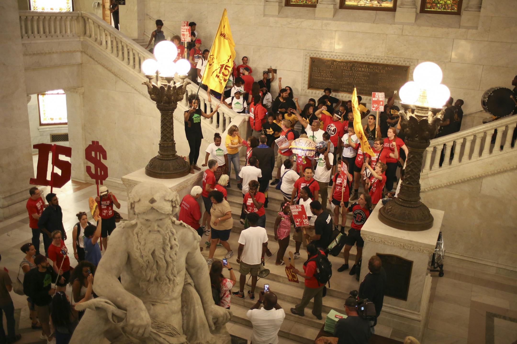 Minimum wage demonstrators rallied in City Hall and heard speeches before handing over a petition with 20,000 signatures on it to the City Clerk.