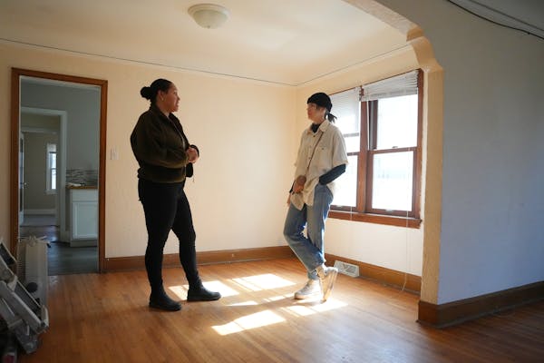 Lakes Area Realty's Mackenzie Owens, left, shows a south Minneapolis home to first-time homebuyer Nicole Neumann.