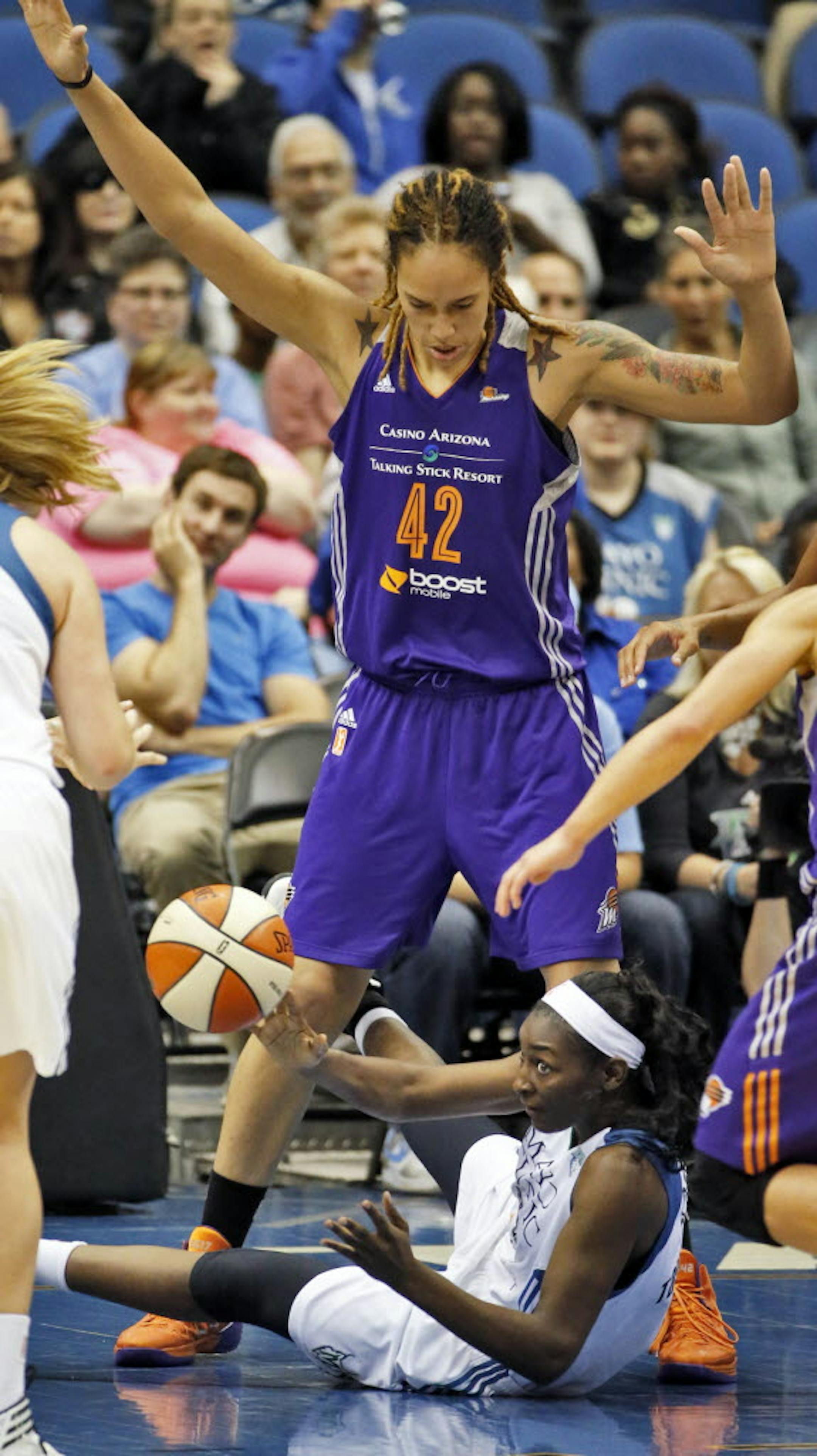 Lynx Asia Taylor looked to pass the ball as Phoenix center Brittney Griner towered over her.