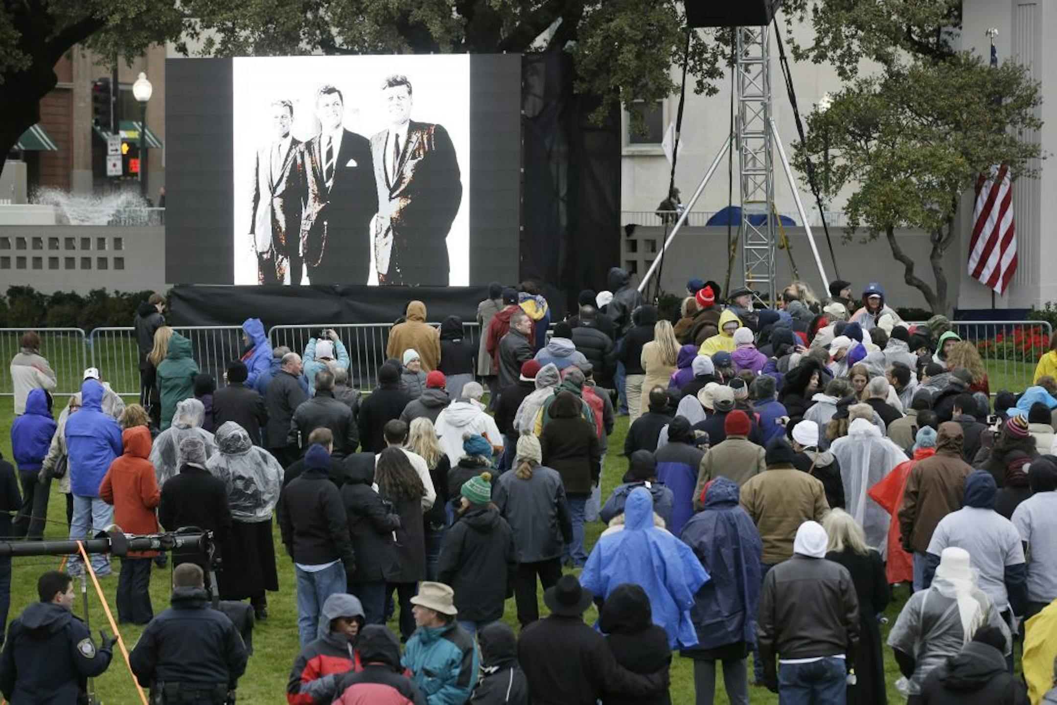 Images of the Kennedys are displayed before a ceremony to mark the 50th anniversary of the assassination of John F. Kennedy, Friday, Nov. 22, 2013, at Dealey Plaza in Dallas.