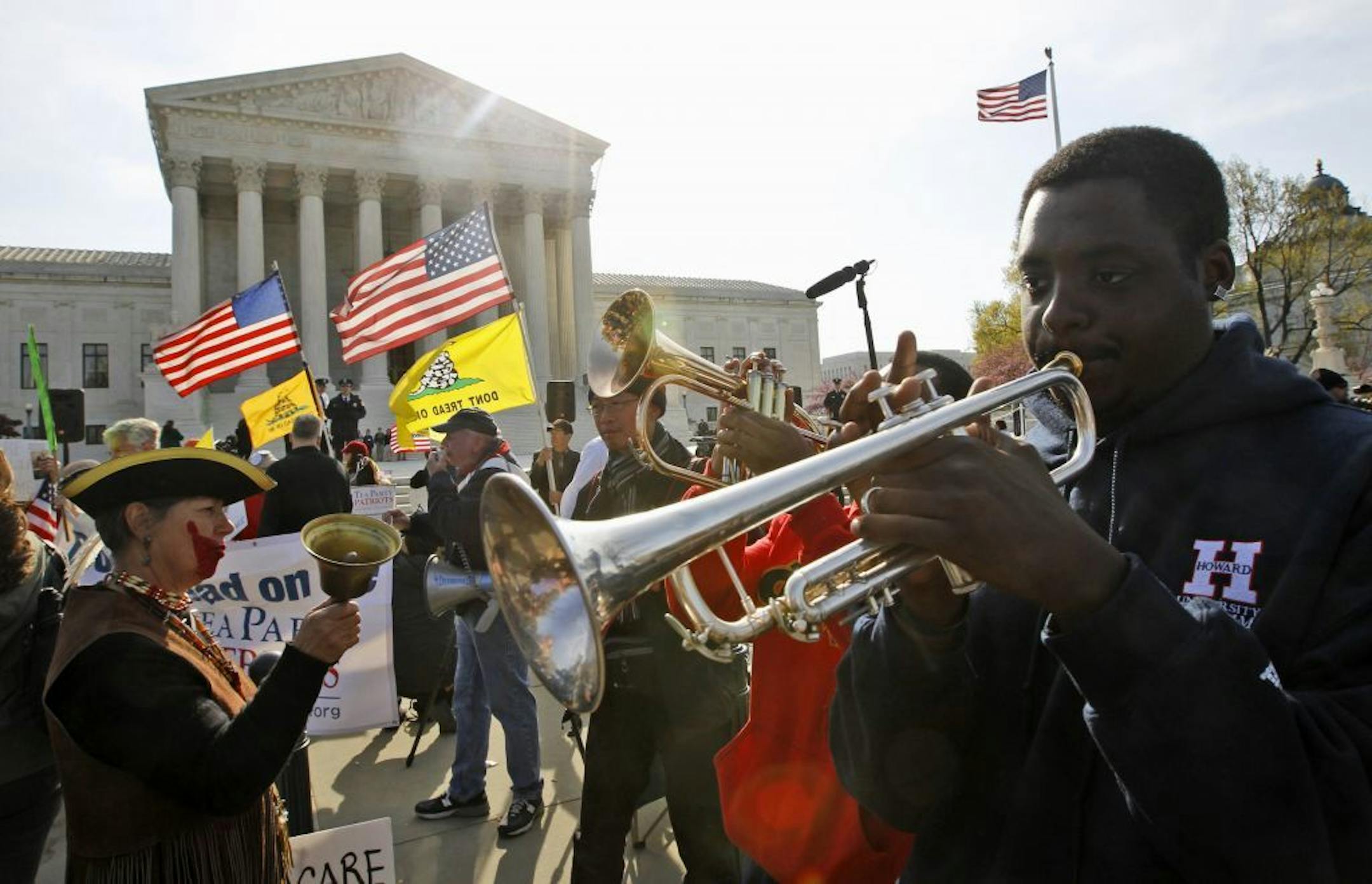 Jonathan Neal, a senior at Howard University, plays his trumpet in support of health care reform in front of the Supreme Court in Washington, Wednesday, March 28, 2012, on the final day of arguments regarding the health care law signed by President Barack Obama.