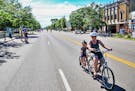Tandem cyclists Kate Bicek and her son James, 5, ride through East Lake Street.