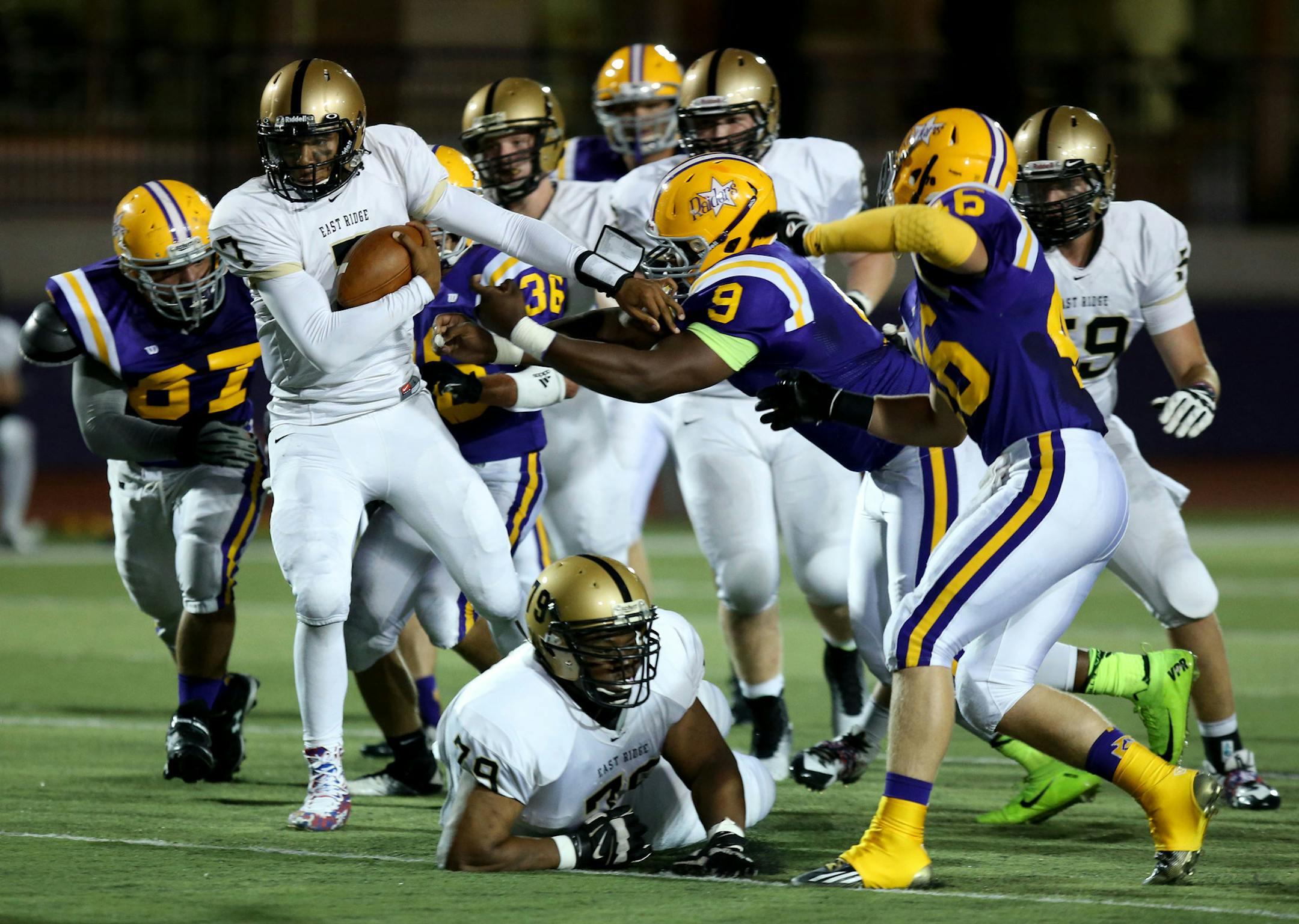 East Ridge quarterback Seth Green ran through the Cretin-Derham Hall defense in the first half. ] (KYNDELL HARKNESS/STAR TRIBUNE) kyndell.harkness@startribune.com Cretin-Derham Hall vs East Ridge in St. Paul Min., Friday, August, 5, 2014.