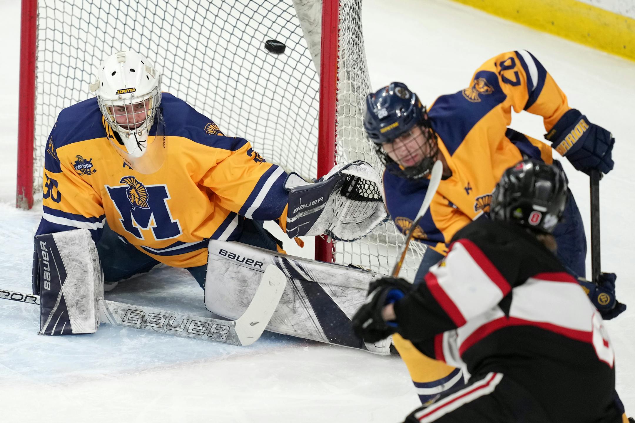 Alexandria forward Gavin Olson (8) scores on Mahtomedi goaltender Charles Brandt (30) in the first period of a MSHSL Class 1A quarterfinal hockey game between Alexandria and Mahtomedi.