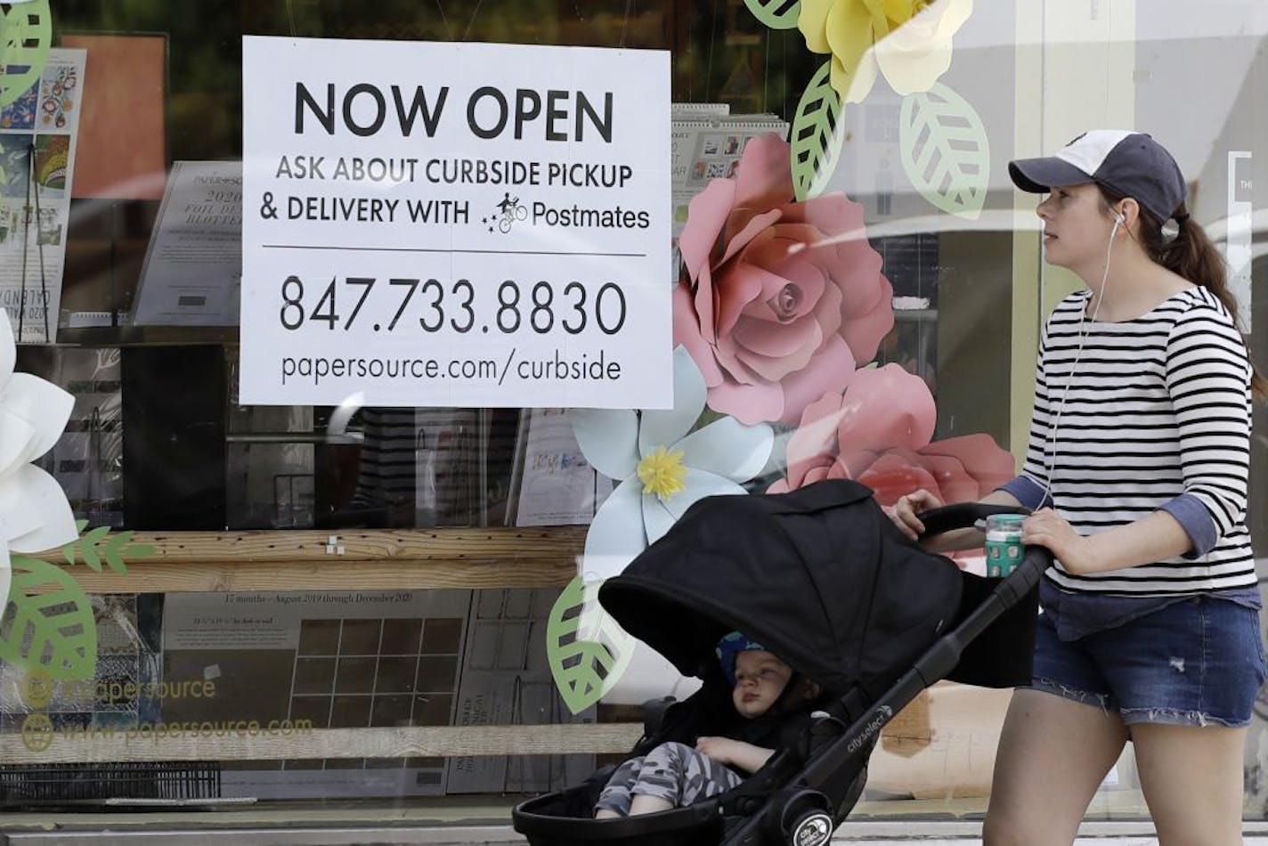 Now Open sign is displayed at a stationary store in Evanston, Ill., Friday, May 29, 2020. Every region of Illinois met the criteria to move into Phase 3 of reopening Friday. Most of the state will do so, but Chicago will have to wait until June 3 to partially reopen. Starting Friday, more businesses such as retail, offices, manufacturing, barbershops and salons will be allowed to reopen and people can start gathering in small groups while social distancing and face covering will also be necessar