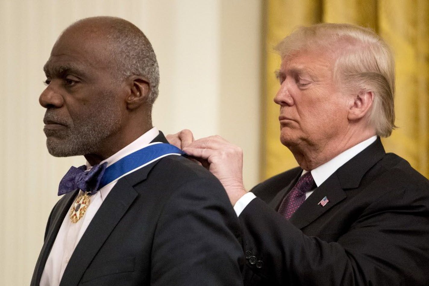 President Donald Trump awards former professional football player and Minnesota Supreme Court Associate Justice Alan Page the Medal of Freedom during a ceremony in the East Room of the White House in Washington, Friday, Nov. 16, 2018.