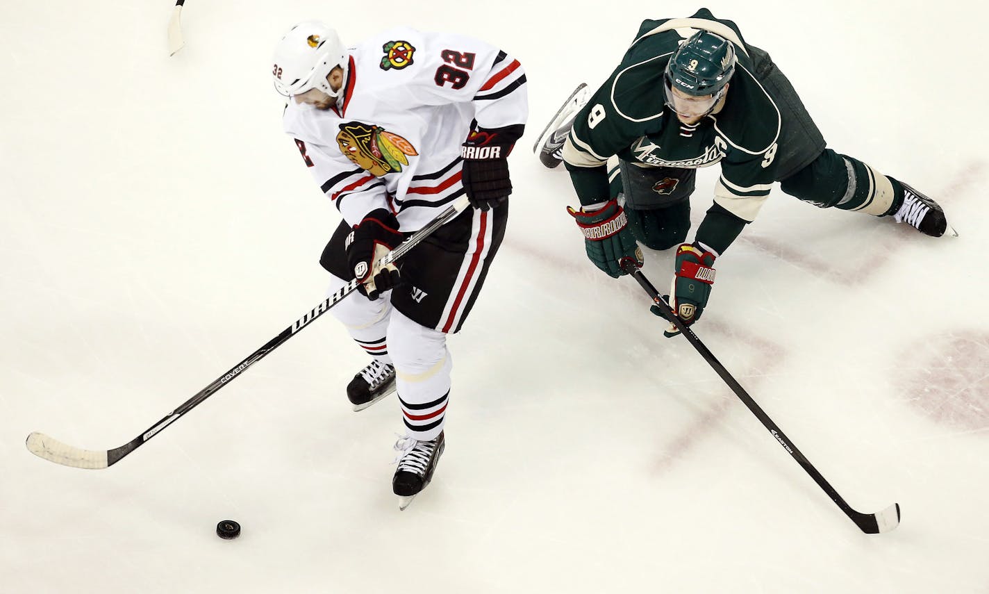 Michal Rozsival (32) and Mikko Koivu (9) fought for the puck in the second period. ] CARLOS GONZALEZ cgonzalez@startribune.com - May 6, 2014, St. Paul, Minn., Xcel Energy Center, NHL, Minnesota Wild vs. Chicago Blackhawks, Stanley Cup Playoffs Round 2, Game 3