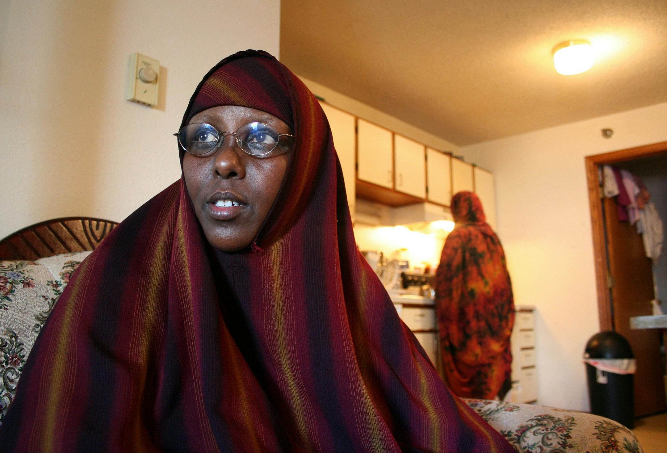 FILE - In this July 30, 2009 file photo, Hawo Mohamed Hassan, seated in her friend's living room, tells Minnesota Public Radio that eight FBI agents raided her Rochester, Minn. apartment on July 13, 2009. One of two indictments issued Thursday Aug. 5, 2010 in Minnesota alleges that two Somali women who were among those charged, including Hassan and others, went door-to-door in Minneapolis; Rochester, Minn., and elsewhere in the U.S. and Canada to raise funds for al-Shabab's operations in Somalia