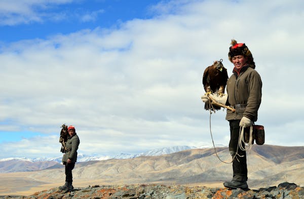 3) Eagle hunters Ushkish and Berik at the top of the mountain preparing to hunt.