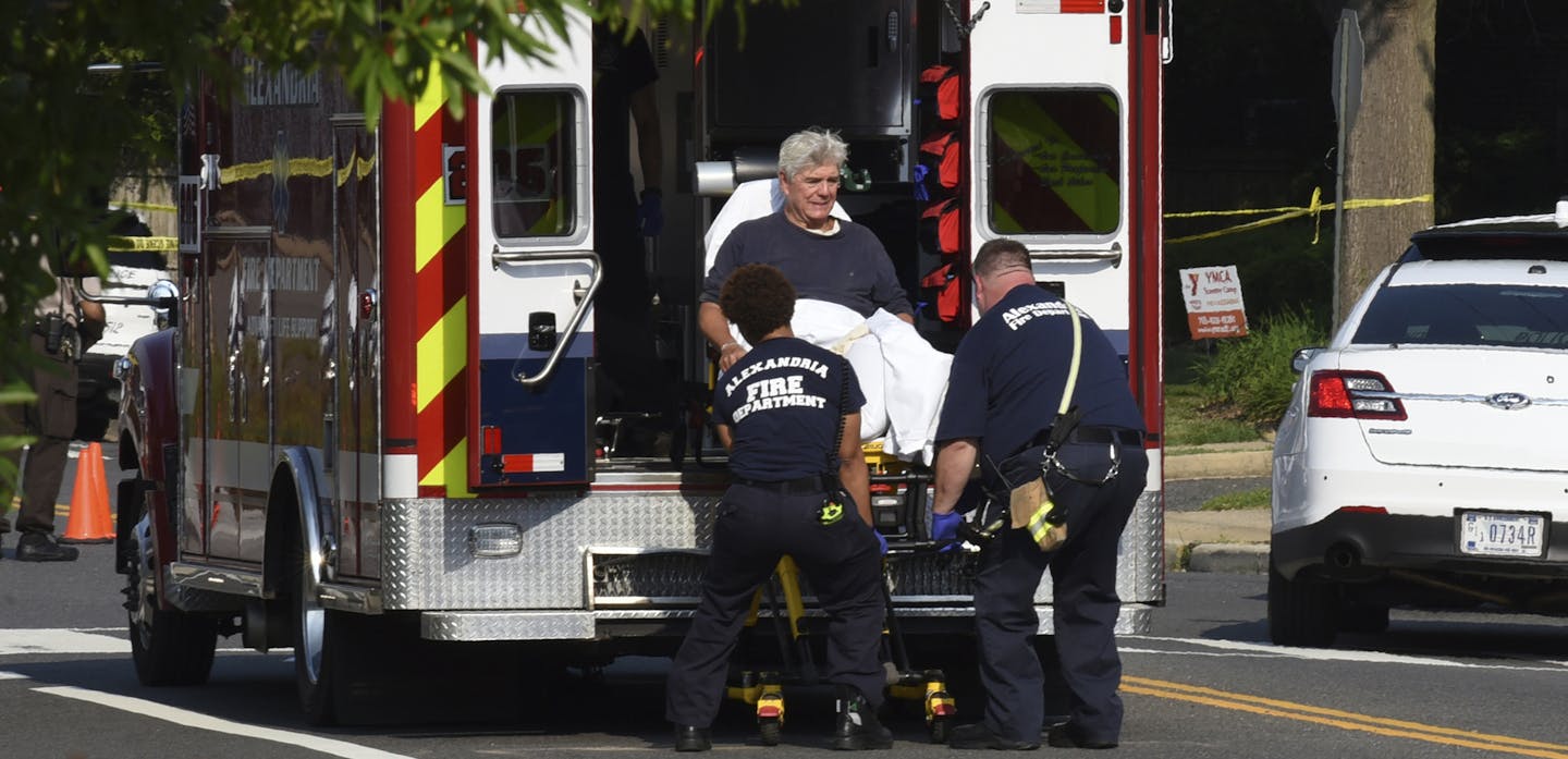 Rep. Roger Williams, R-Texas is placed into an ambulance at the scene of a shooting at a baseball field in Alexandria, Va., Wednesday, June 14, 2017. Members of Congress were practicing for a game when a gunman started shooting. (AP Photo/Kevin S. Vineys) ORG XMIT: VAKV102