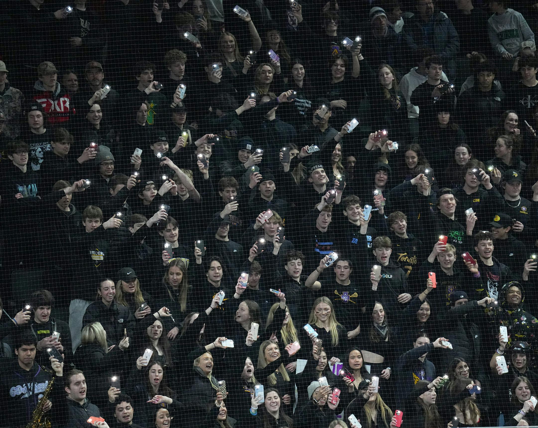 Cretin-Derham Hall players and fans celebrate after the last goal of the game in the third period.