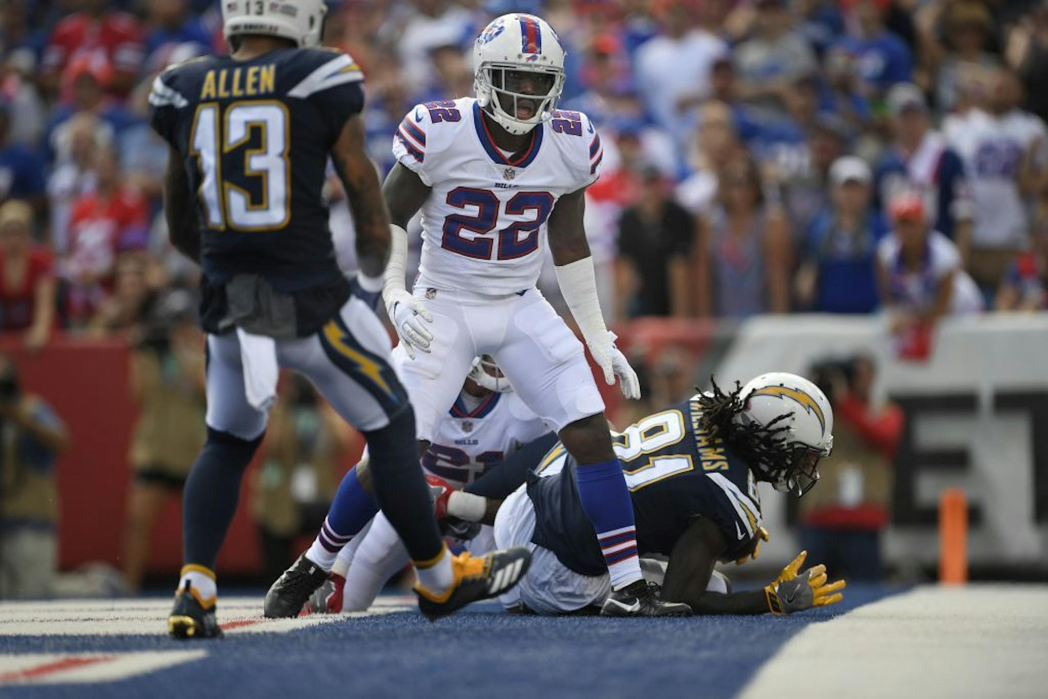 Buffalo Bills' Vontae Davis, center, gets up after Los Angeles Chargers' Mike Williams, right, scores a touchdown during the first half of an NFL football game, Sunday, Sept. 16, 2018, in Orchard Park, N.Y. How's THAT for a halftime adjustment? While the rest of the Buffalo Bills jogged into the locker room at halftime of their game against the Los Angeles Chargers, cornerback Vontae Davis jogged in, then just kept on going. Later, Davis posted on Twitter that he was, in fact, calling it a caree