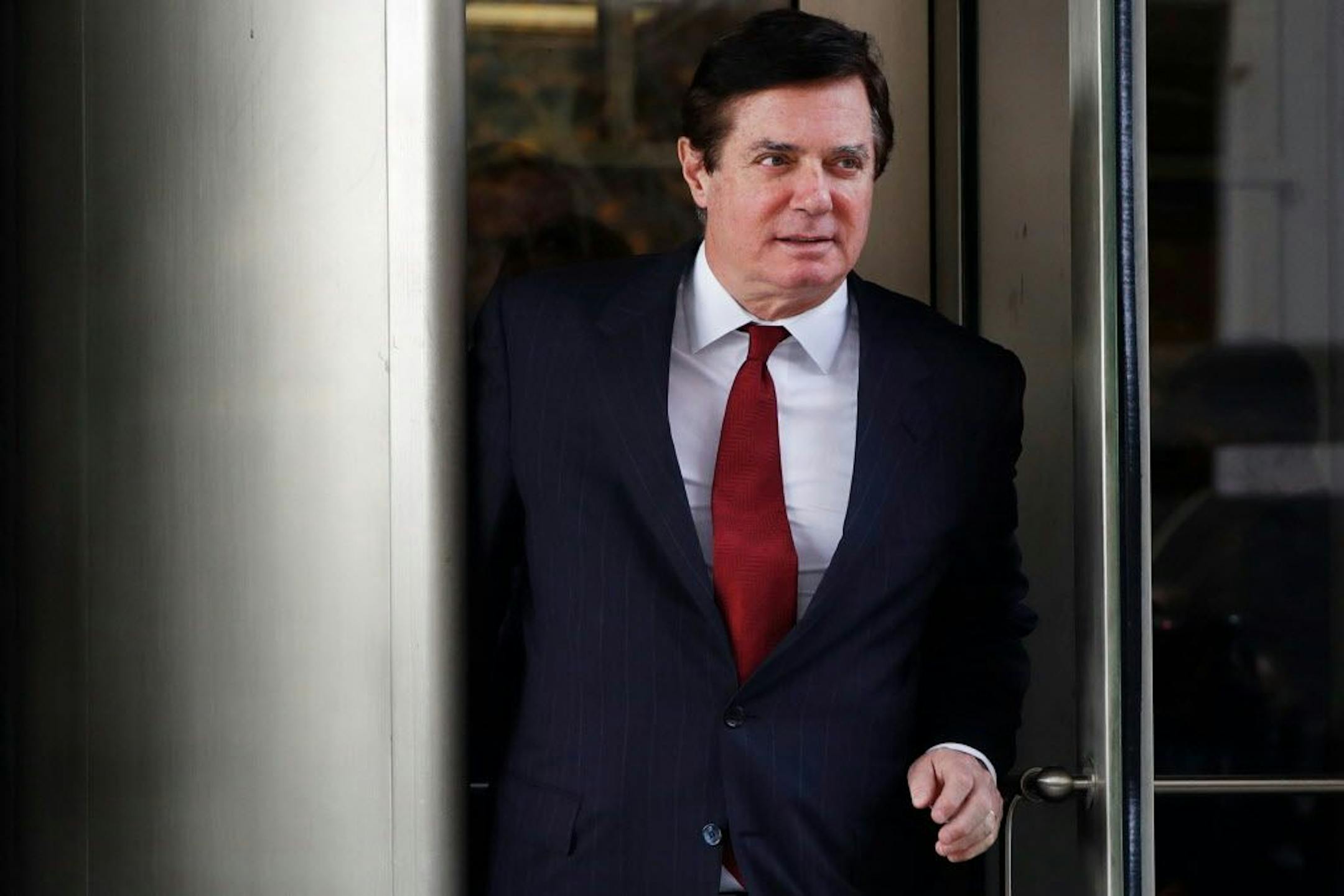 FILE - In this Nov. 6, 2017, file photo, Paul Manafort, President Donald Trump's former campaign chairman, leaves the federal courthouse in Washington. A federal judge in Washington has thrown out a civil lawsuit brought by President Donald Trump's former campaign chairman that sought to challenge the authority of the special counsel in the Russia investigation. The decision was a blow to Manafort's defense against special counsel Robert Mueller. U.S. District Judge Amy Berman Jackson issued the