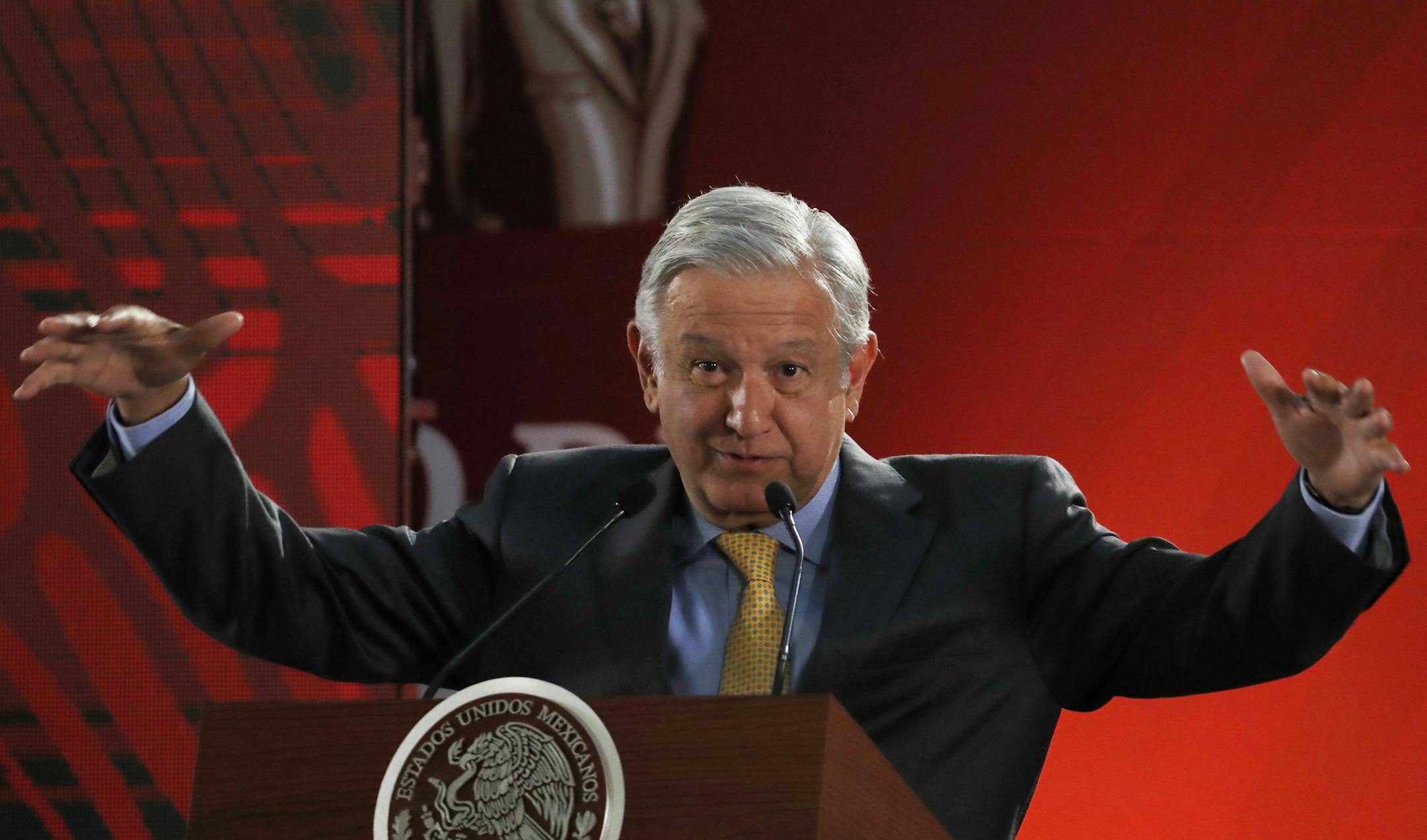 In this March 8, 2019 photo, Mexican President Andres Manuel Lopez Obrador speaks to journalists at his daily 7 a.m. press conference at the National Palace in Mexico City. Lopez Obrador's first 100 days in office have combined a compulsive shedding of presidential trappings with a dizzying array of policy initiatives, and a series of missteps haven't even dented his soaring approval ratings.(AP Photo/Marco Ugarte)