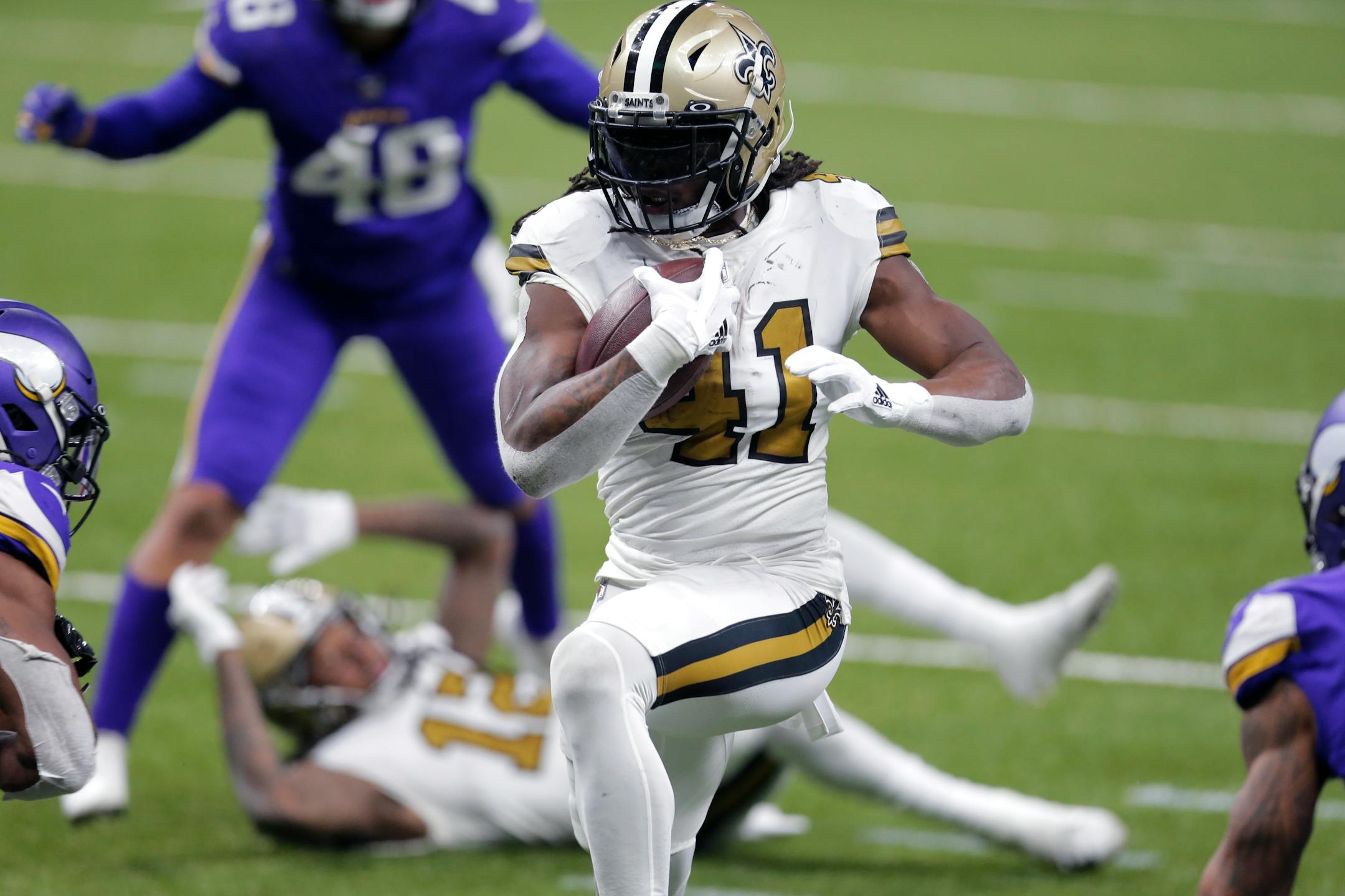 New Orleans Saints running back Alvin Kamara (41) carries for his fourth touchdown of the game, in the second half of an NFL football game against the Minnesota Vikings in New Orleans, Friday, Dec. 25, 2020. (AP Photo/Brett Duke)