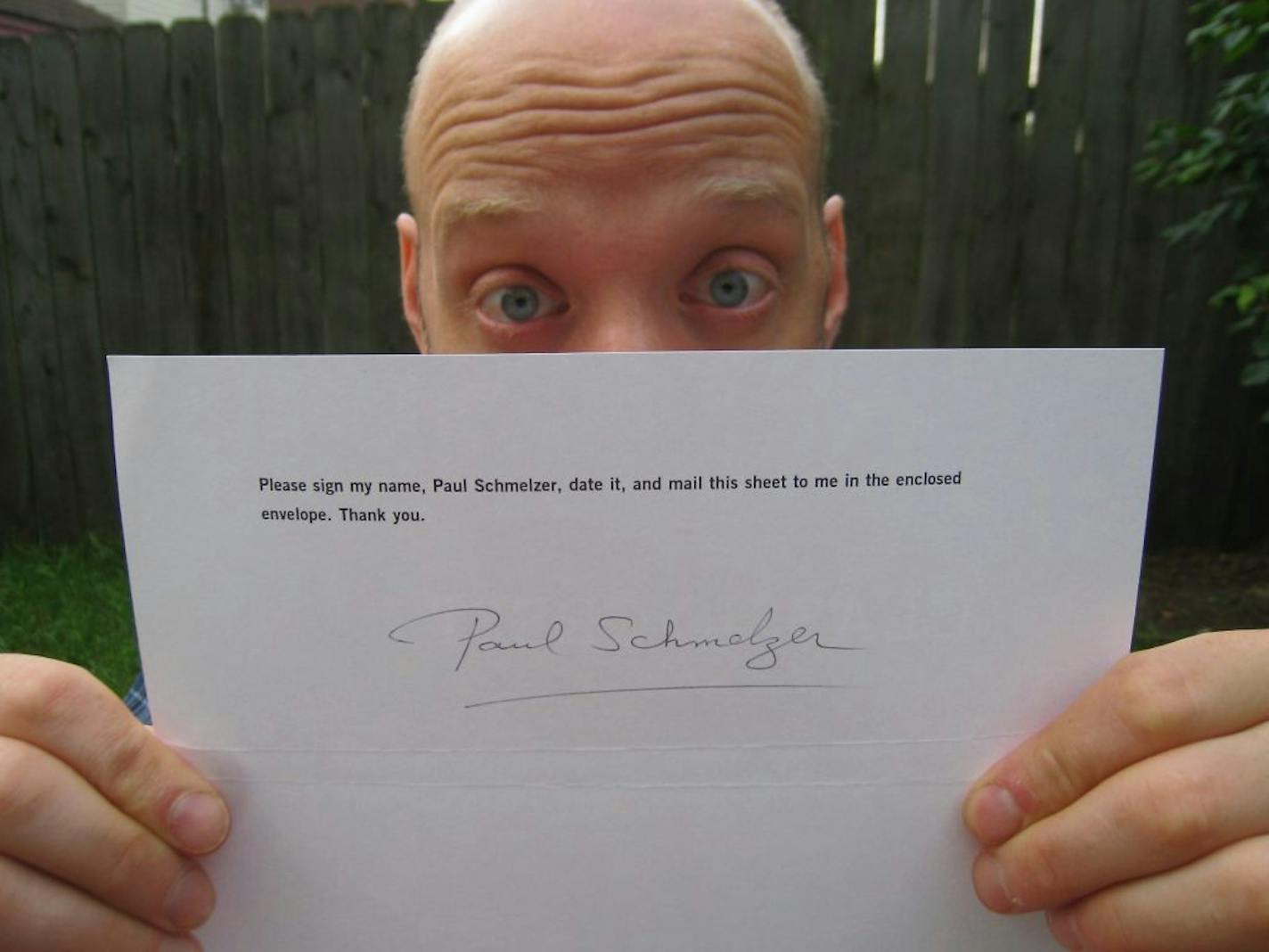 Paul Schmelzer holding an "autograph" from Isabelle Allende