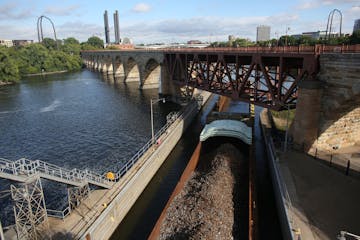 The tug boat Becky Sue pushed two barges one and empty and this one with recycled metal through the St. Anthony Falls Lock and Dam in Minneapolis Wedn