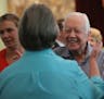 Former President Jimmy Carter reaches to embrace his brother Billy's widow Sybil while greeting family Sunday, Aug. 16, 2015, following service at Mar