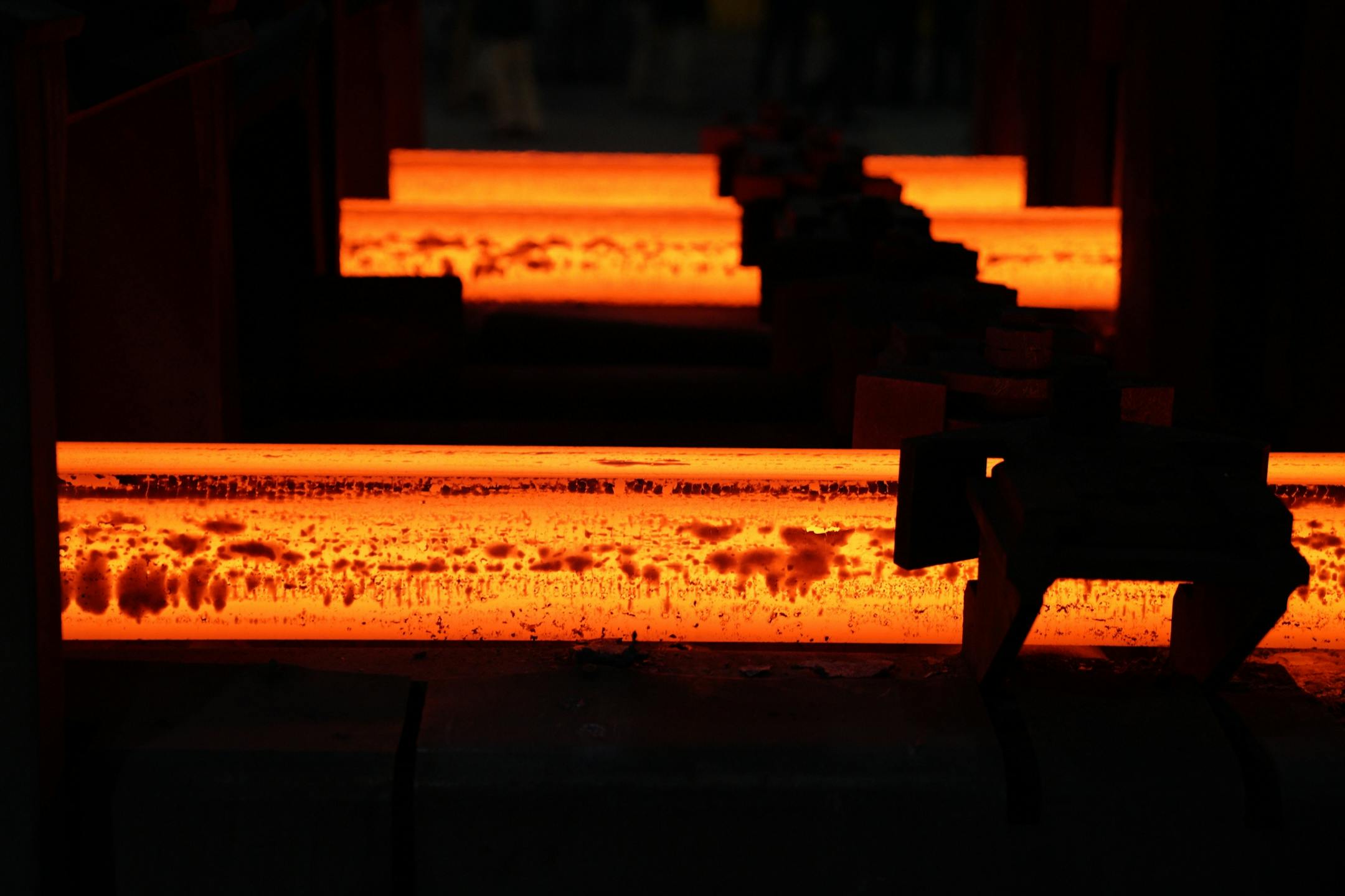 Hot steel bars still glowing orange came passed by during Vice President Mike Pence's tour of Gerdau Ameristeel Thursday.