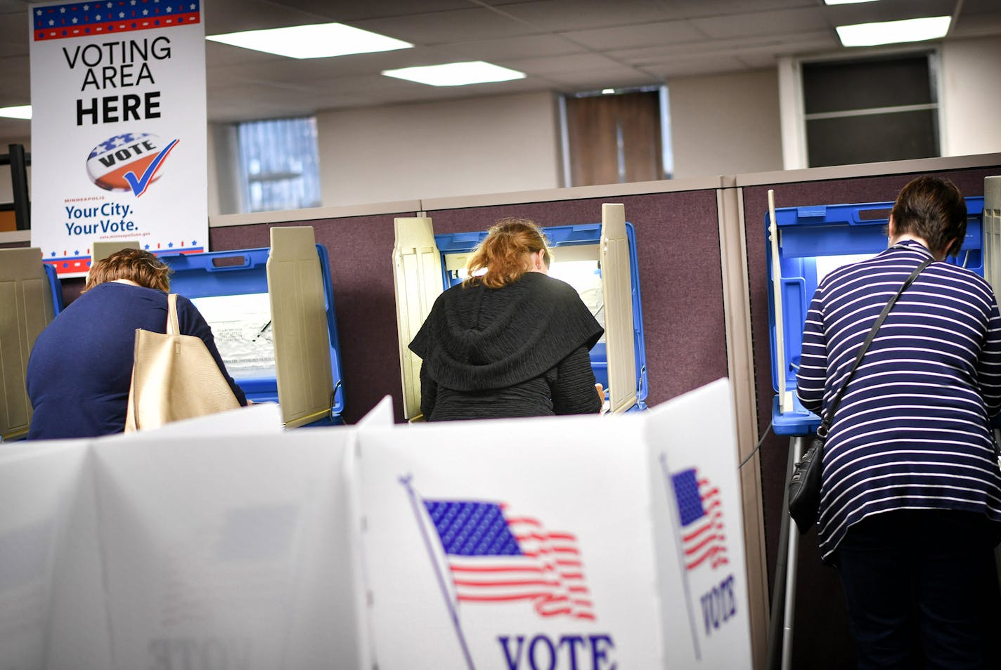 Voters cast their ballots at a voting center in Minneapolis Friday, Sept. 23, 2016. Friday kicked off the state's early voting period, making Minnesota among the first states to open up voting. It's the state's second election with early voting as an option but the first during a presidential contest. (Glen Stubbe/Star Tribune via AP) ORG XMIT: MIN2016093017575455 ORG XMIT: MIN1611071410550018