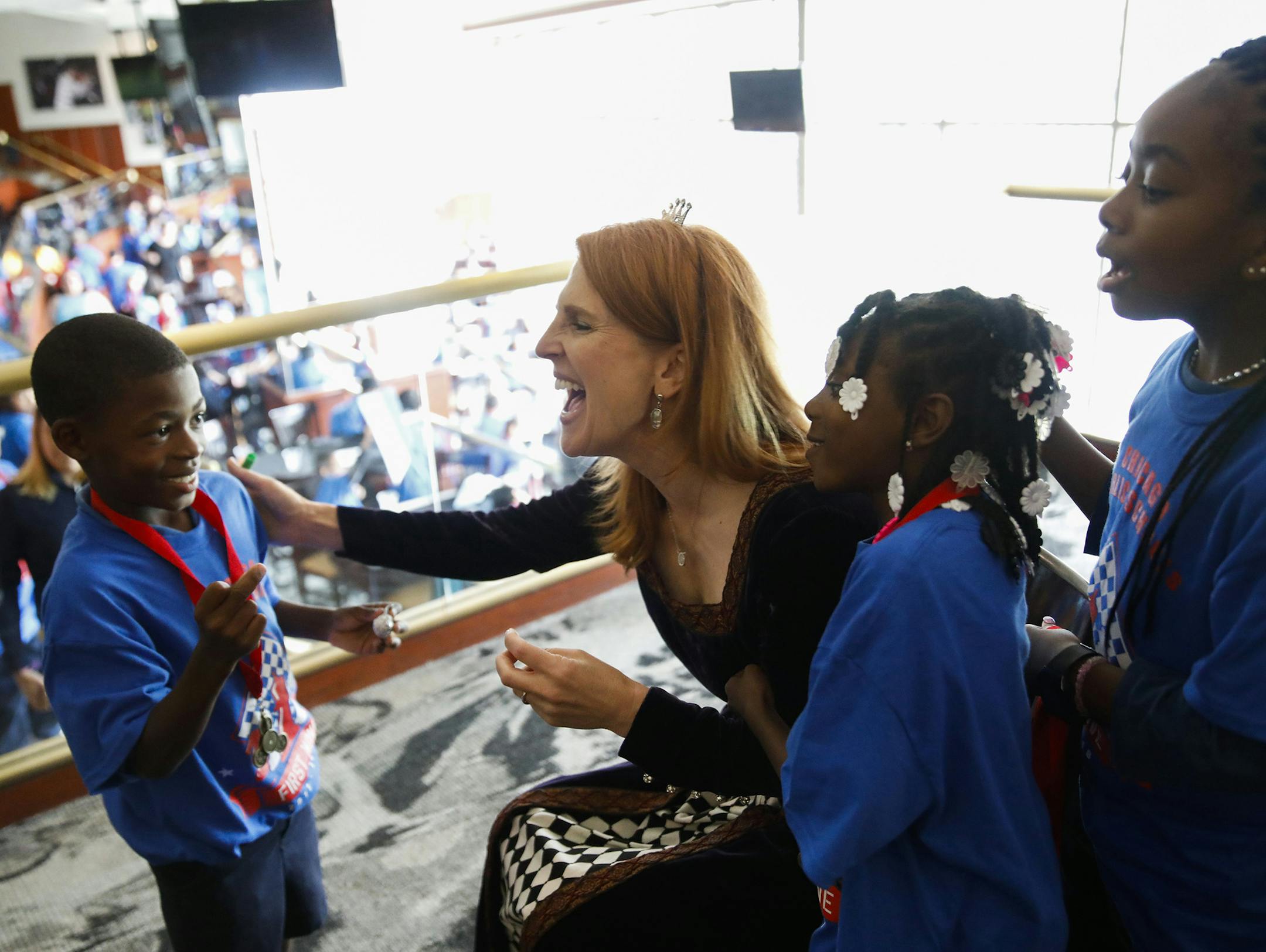 Wendi Fischer, aka The Chess Lady, center, talks to children from Dewey Elementary on Friday, June 8, 2018 after a group photo following a chess event at Guaranteed Rate Field in Chicago, Ill. (Jose M. Osorio/Chicago Tribune/TNS)