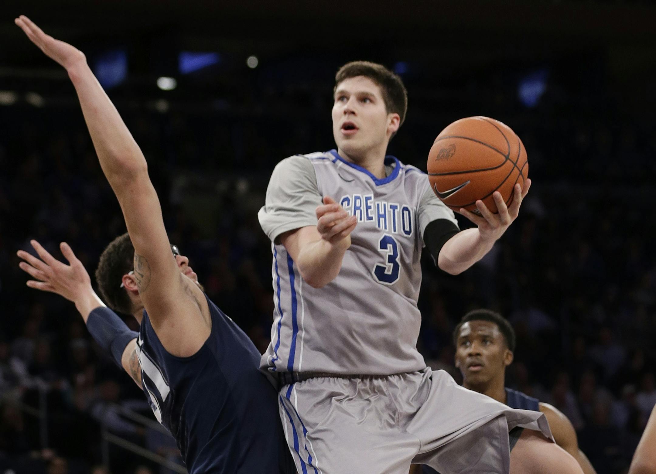 Creighton's Doug McDermott (3) drives past Xavier's Isaiah Philmore during the first half of an NCAA college basketball game in the semifinals of the Big East Conference tournament Friday, March 14, 2014, at Madison Square Garden in New York. (AP Photo/Frank Franklin II) ORG XMIT: MSG123