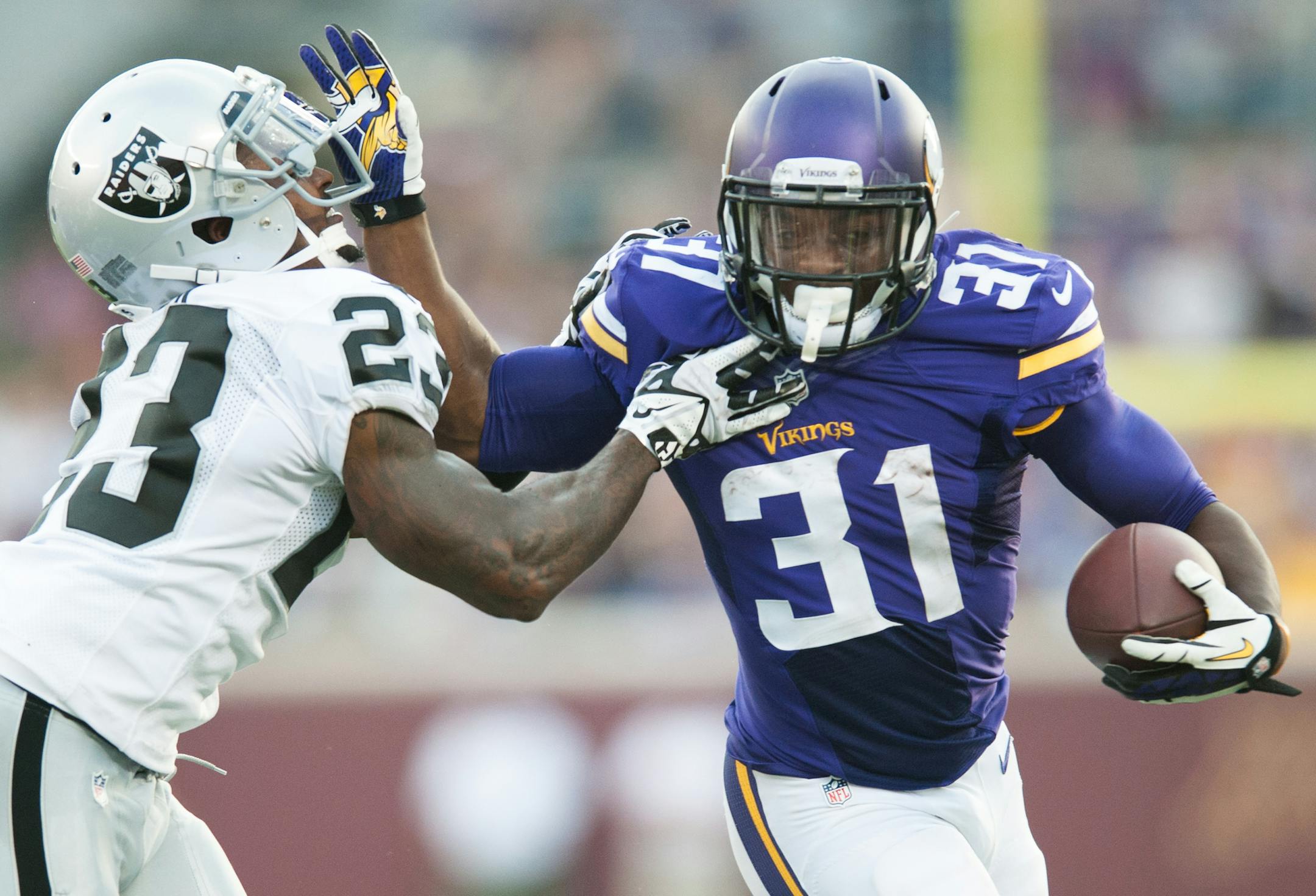 [VIKE080914 * 20035696A * 523370 * Mark Vancleave/MARK.VANCLEAVE@STARTRIBUNE.COM * Vikings vs. Oakland Raiders, Aug. 8, 2014 at TCF Bank Stadium.] Vikings running back Jerick McKinnon runs the ball against Raiders corner back Tarell Brown in the first quarter.