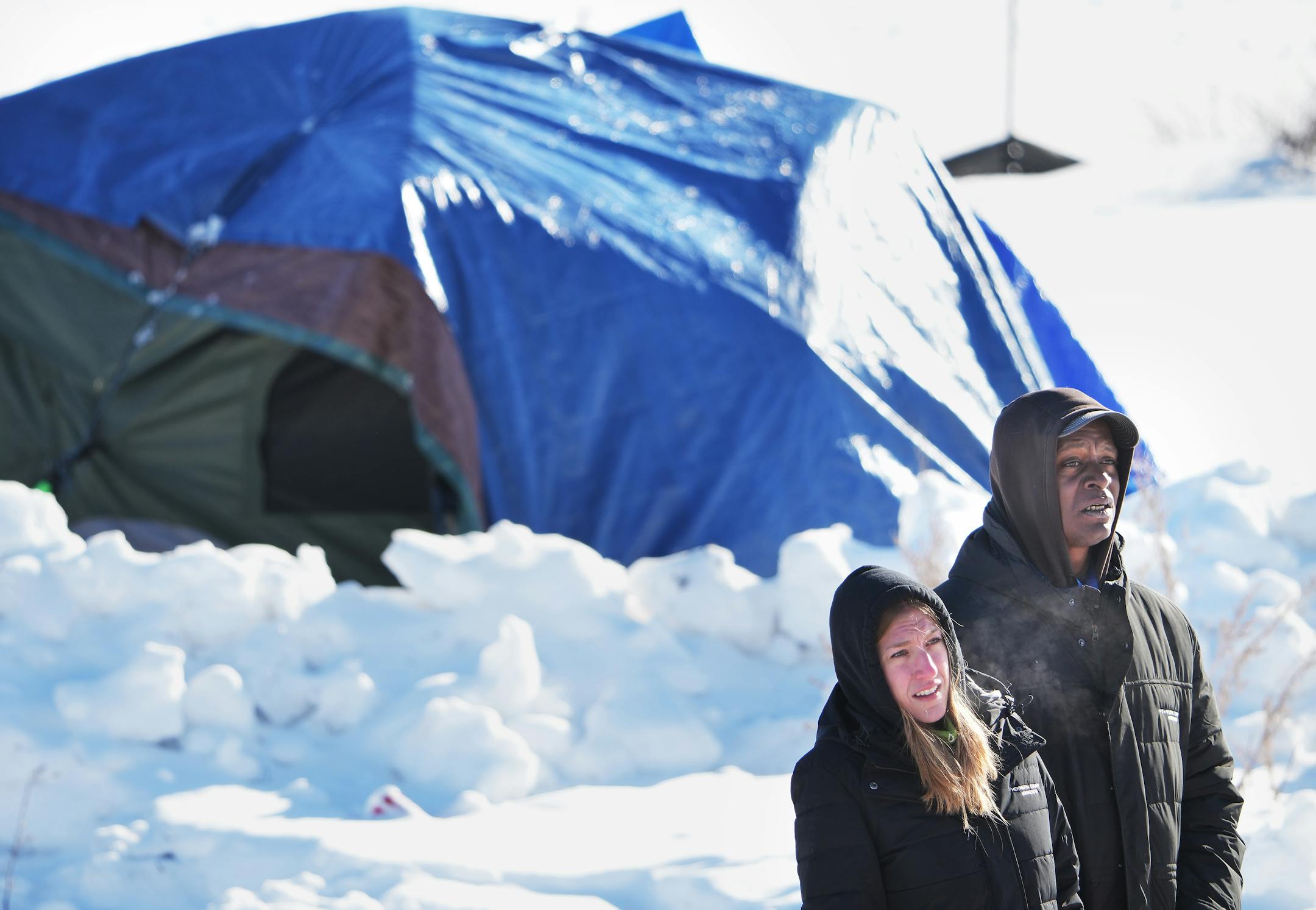 Mim Buckland, left, and Randy Flowers, both of the Hennepin County Streets 2 Housing program, look for residents of a homeless encampment off of the 3000 block of Snelling Avenue, near Hiawatha Ave., as part of Hennepin County's "Point in Time," count of homeless people Thursday, Jan. 26, 2023 in Minneapolis.